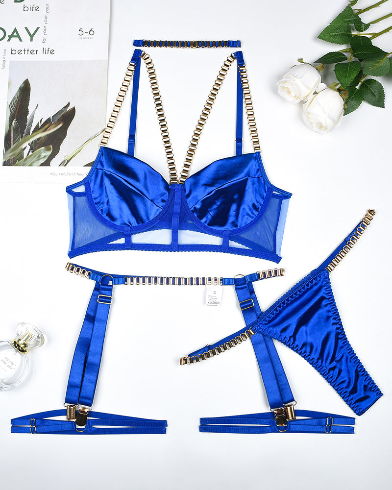 Blue lingerie set flat lay: underwire bra, garter straps, thong, and choker accessory