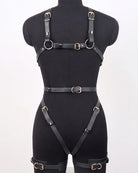 Black faux leather full-body harness with wide chest band, hip straps, and leg cuffs