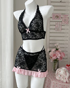 Black lace halter bra and mini skirt set on mannequin with pink ruffle trim