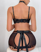 Black lace lingerie set with leopard trim garter belt and chain choker, back view