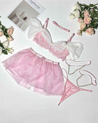 Pink tulle lingerie set flat lay with off-shoulder bra, skirt, and garter straps