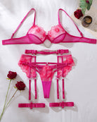 Hot pink floral lace lingerie set laid flat: bra, thong, garters, and straps