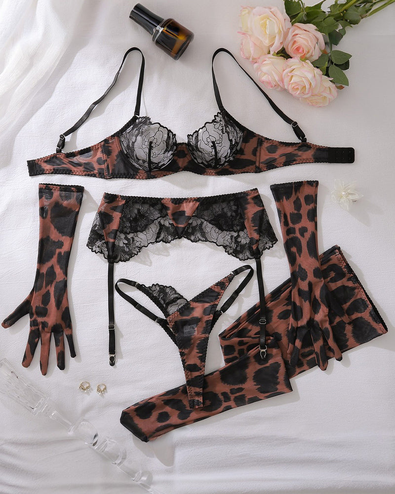 Leopard lace lingerie set laid flat: bra, thong, garter belt, stockings, gloves, socks