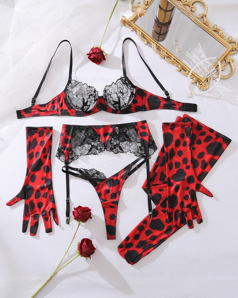 Wine red leopard lace lingerie set laid flat: bra, thong, garter belt, stockings and gloves