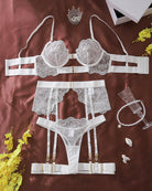 White lace lingerie set with underwire bra, garter belt, thong, and thigh straps
