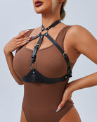 Black leather chest belt with multiple adjustable straps and round ring hardware