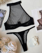 Fishnet halter mesh bra and thong set, black, flat lay of bra and thong