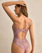 Lilac lace bodysuit with sheer back and floral cutouts, adjustable straps