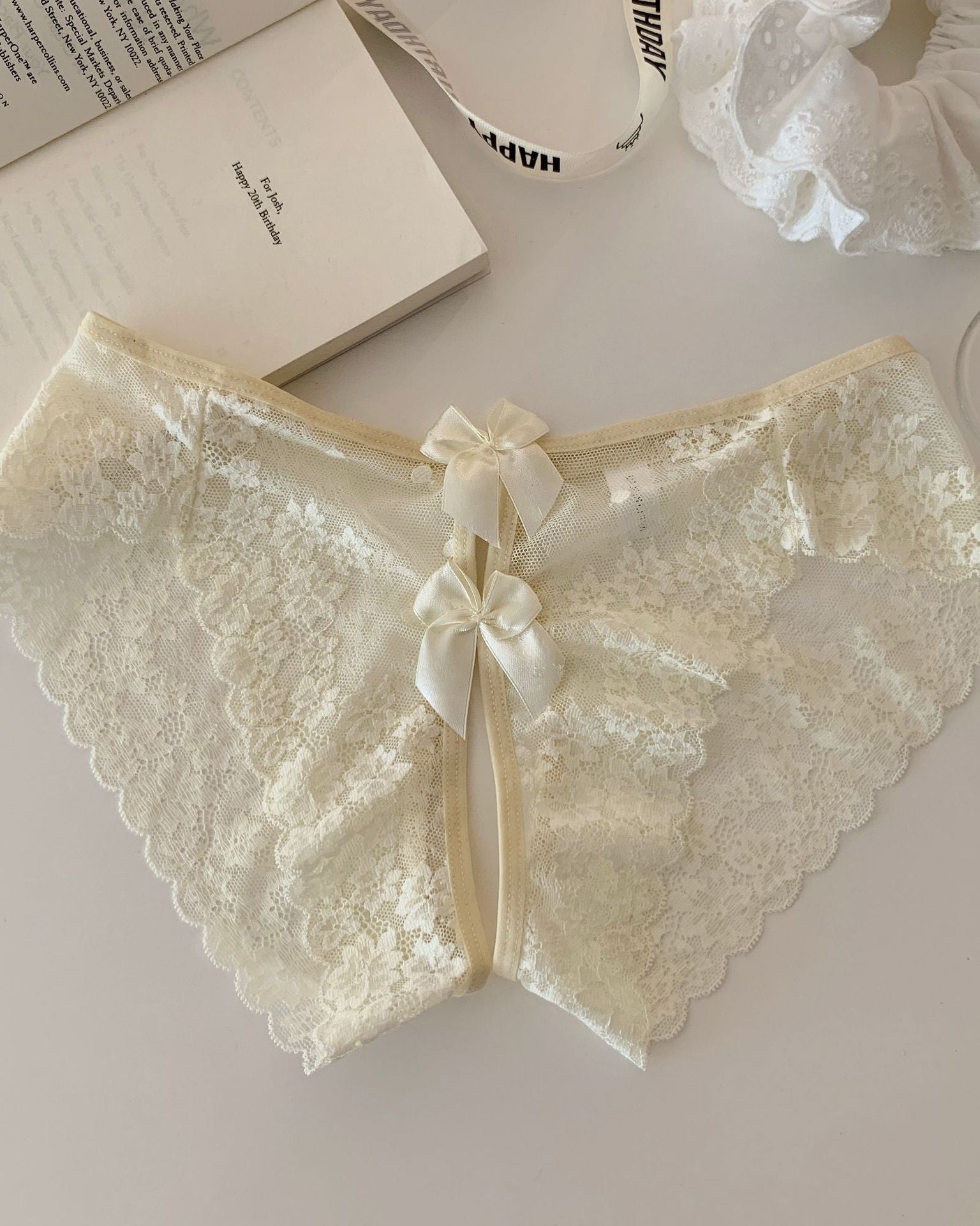 Sheer floral lace bow-back panties in ivory with satin ribbon bow accents