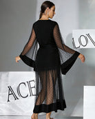 Black belted robe dress, V-back view, semi-sheer polka-dot sleeves and flared cuffs