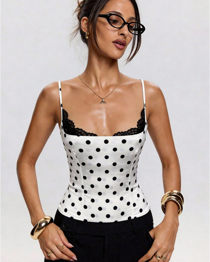 White polka dot bustier-style crop top with black lace-trim neckline and spaghetti straps