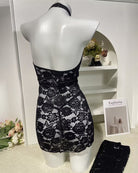 Black lace halter bodycon mini dress with cutout detail, on mannequin