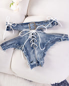 Blue denim cutout lace-up thong shorts with frayed edges and waist ties