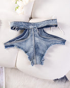 Blue denim cutout thong shorts with lace-up straps and frayed V-shaped back