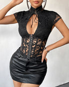 Black tie-front corset top with cap sleeves, sheer lace panels and front grommet lacing