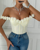White off-shoulder corset bodysuit with scalloped floral trim and vertical seams