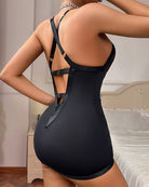 Black studded halter mesh mini dress with crisscross straps and cutout back