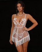 White sheer babydoll lingerie with floral lace cups, V-strap front, and fringe mini hem