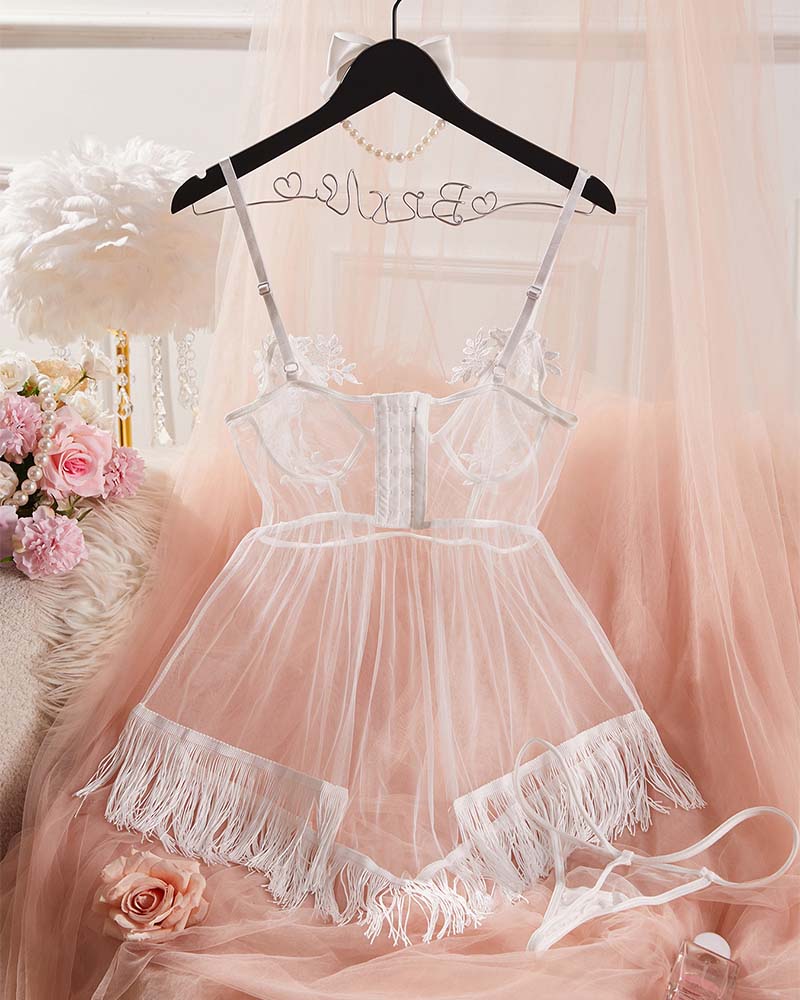 White sheer babydoll lingerie with floral lace trim and fringe panels on garment hanger