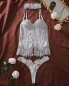 Silver lace bustier corset lingerie set with thong, flat lay