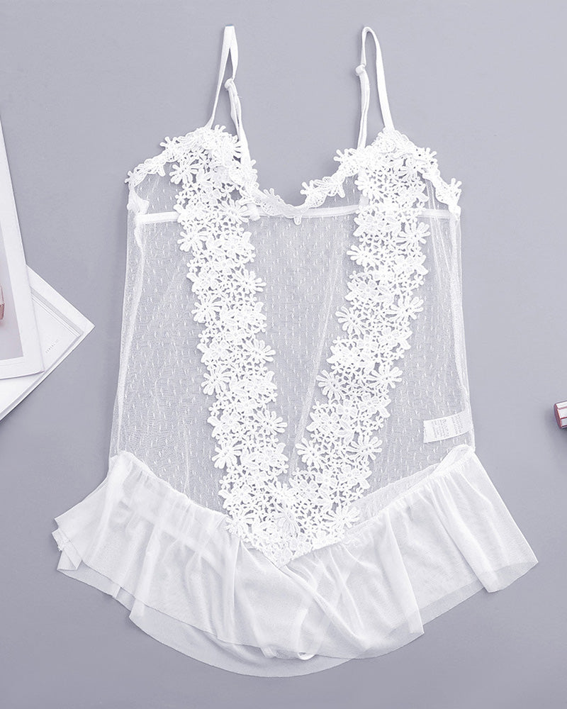 White sheer lace bodysuit with floral appliques and ruffle hem, laid flat