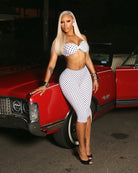 White polka dot halter crop top and high-waist capri pants set, worn with heels