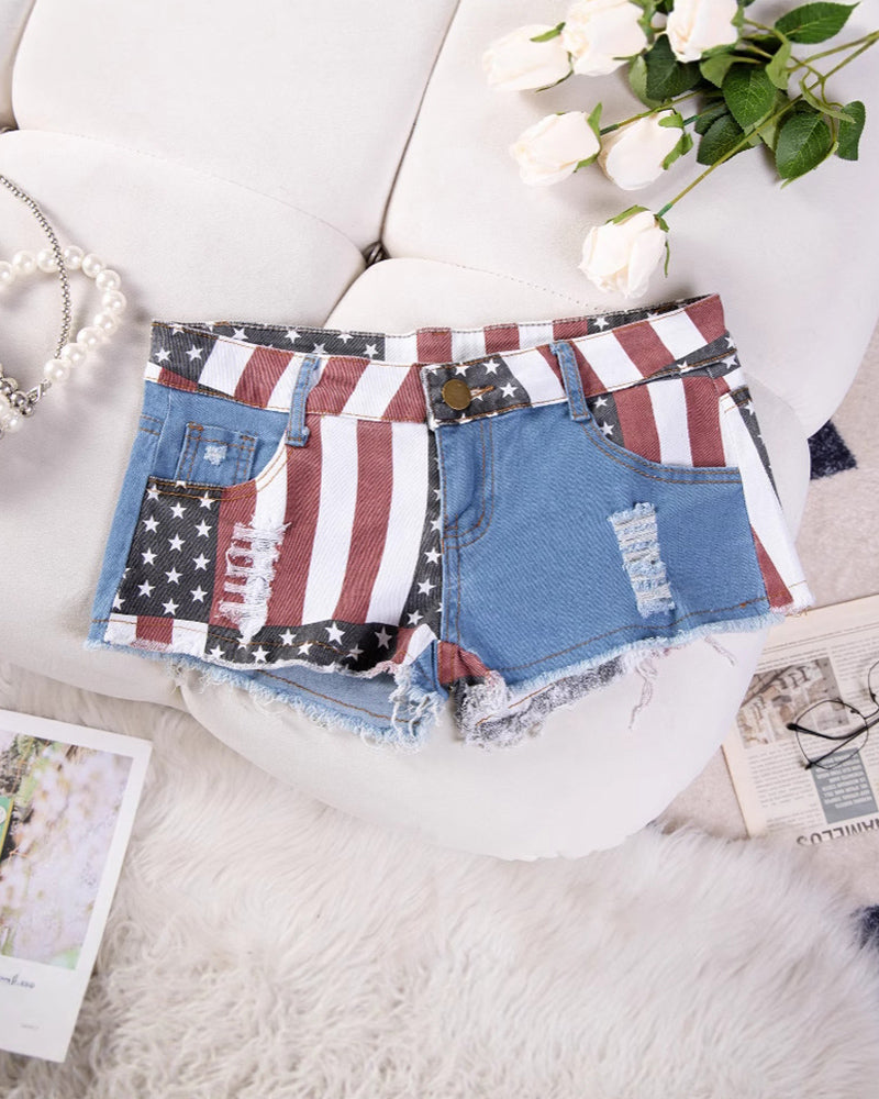 High-waisted denim shorts with American flag patch design, distressed cut and frayed hem