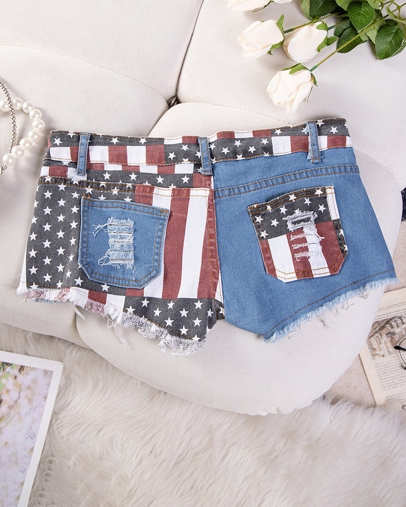 High-waisted denim shorts with flag-themed patchwork pockets and frayed distressed hem