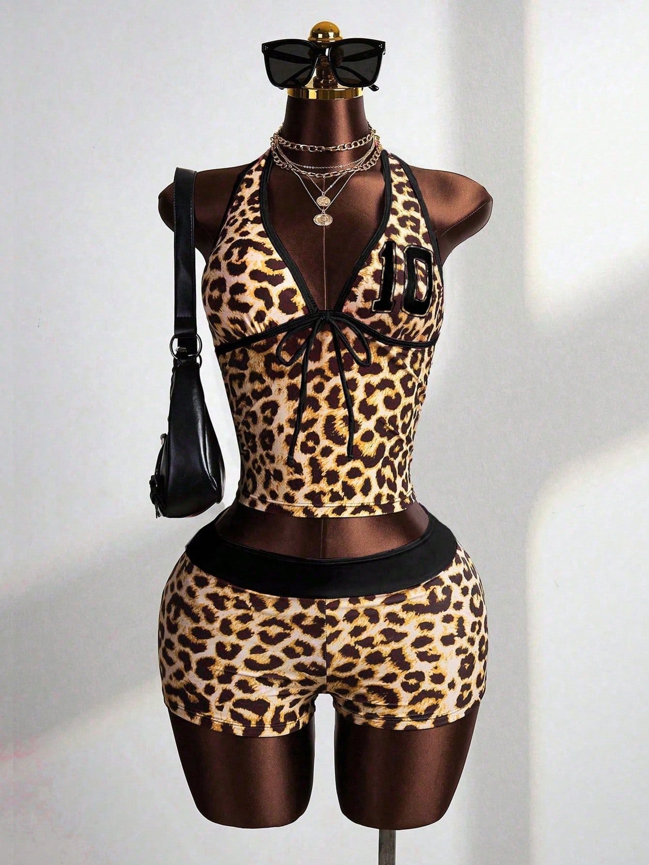 Leopard print halter crop top and high-waisted shorts set, black trim, front on mannequin