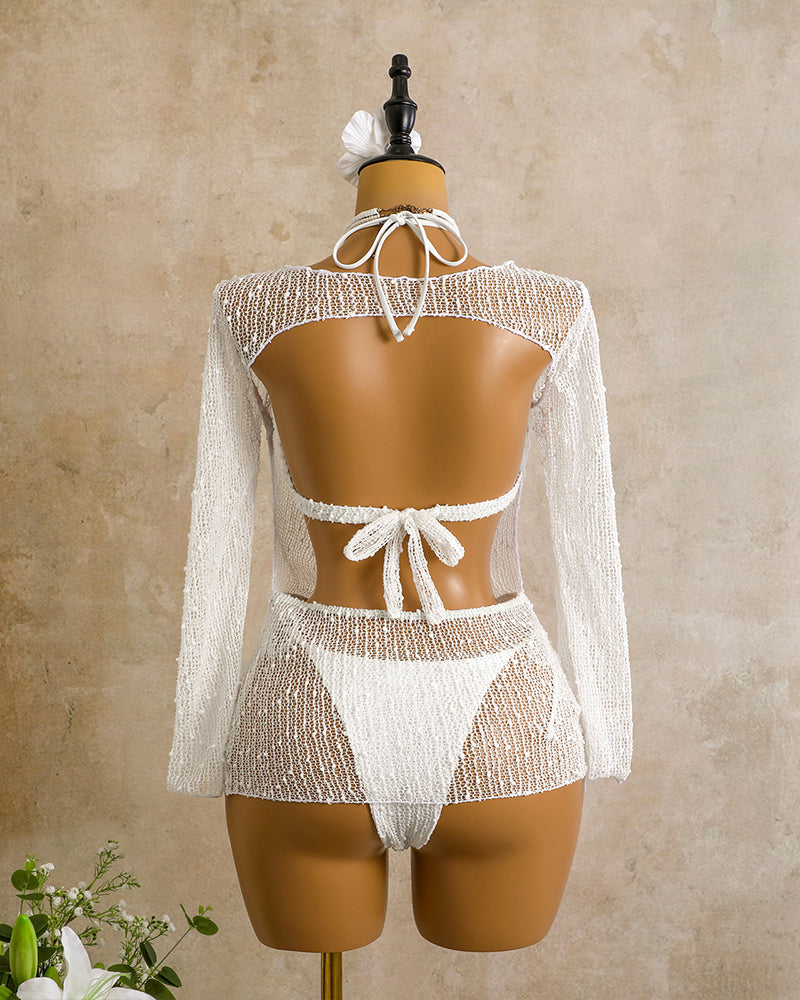 Back view of sheer crochet white bikini set on mannequin, open back and tie strings