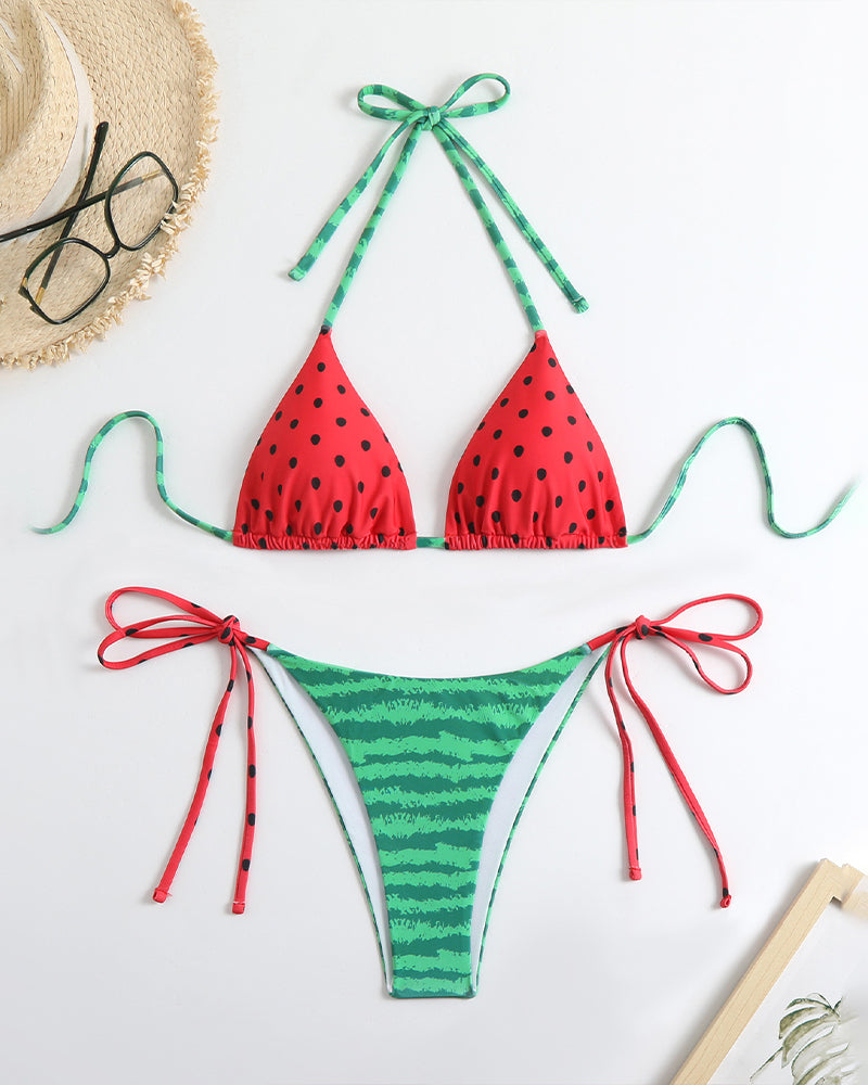 Red polka-dot triangle bikini top and striped side-tie panty set, flat lay