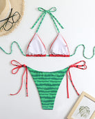 Triangle bikini top and striped side-tie panty set with ribbon ties, flat lay