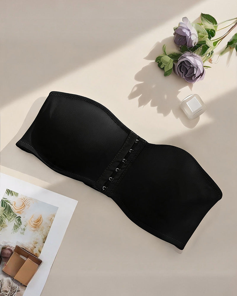 Black strapless bandeau bra with front hook closure, flat lay