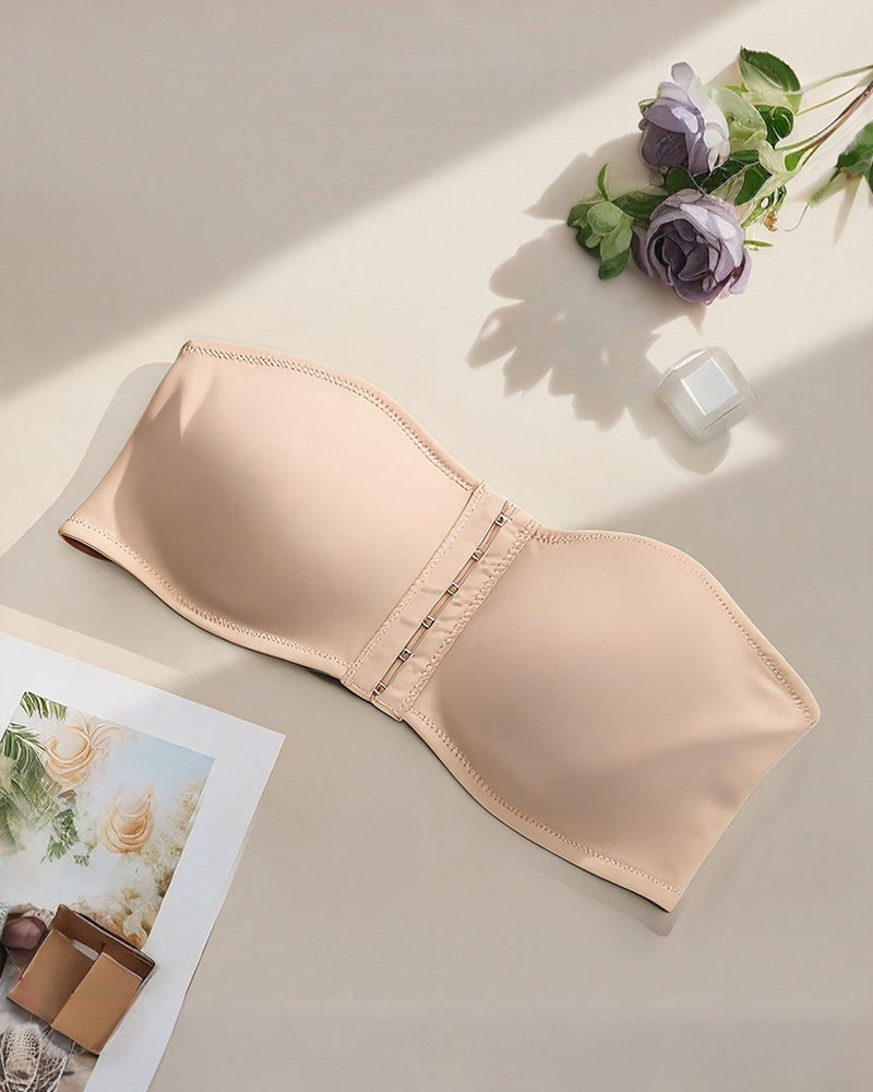 Beige strapless bandeau bra with front hook closure, flat lay