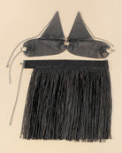 Black rhinestone fringe halter bra and tassel mini skirt, flat lay set