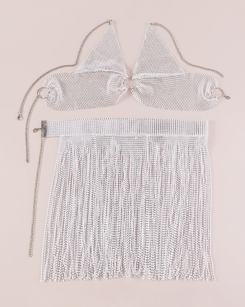 White rhinestone halter bra and tassel mini skirt, flat lay set