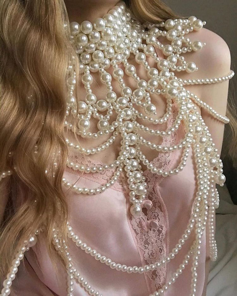 White pearl fringe halter top detail with layered pearl strands and beaded fringe.