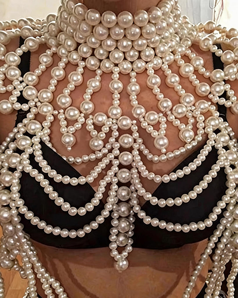 Close-up of pearl body-chain fringe with multiple layered strands and bead clusters.