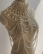 Pearl fringe body chain on mannequin with dense layered loops and dangling strands.