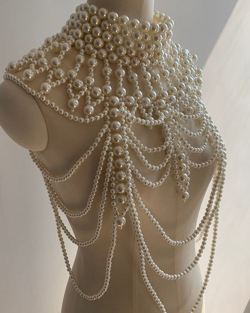 Pearl fringe body chain on mannequin with dense layered loops and dangling strands.