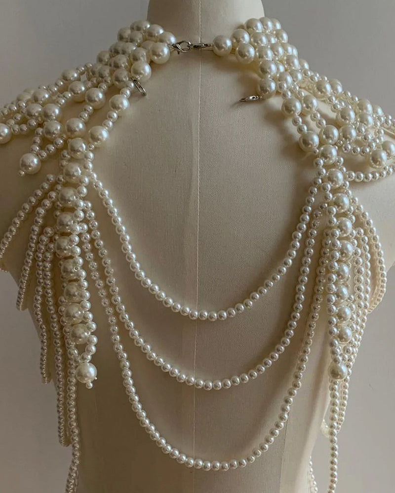 Back view of pearl fringe body chain on mannequin with multiple layered pearl loops.