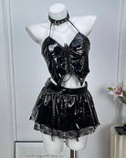 Black leather lingerie set on mannequin: halter crop top, choker, and mini skirt