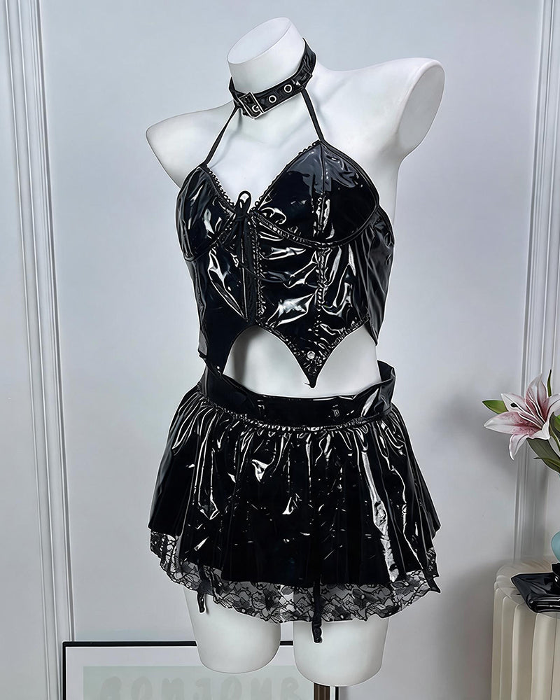 Black leather lingerie set on mannequin: glossy halter crop top and pleated mini skirt