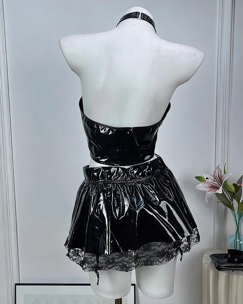 Black leather lingerie set on mannequin, back view: halter crop top and pleated mini skirt