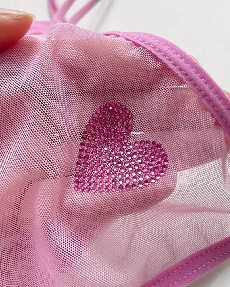 Pink sheer mesh thong with rhinestone heart applique.