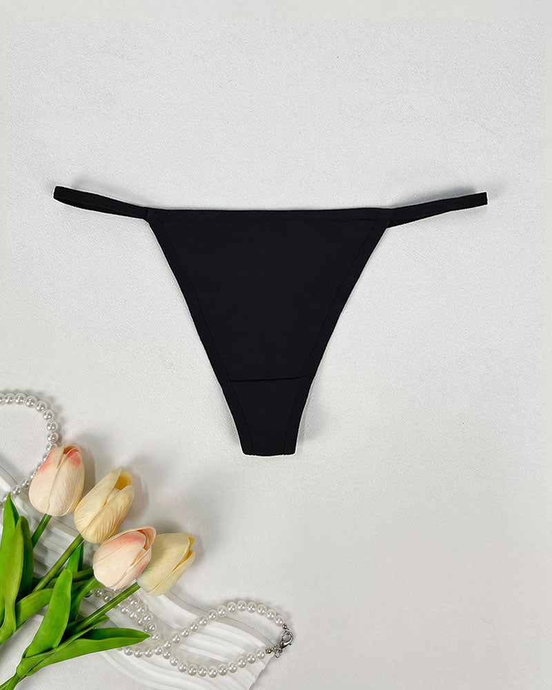 Seamless low-rise thong panties in black, smooth minimal-coverage design.