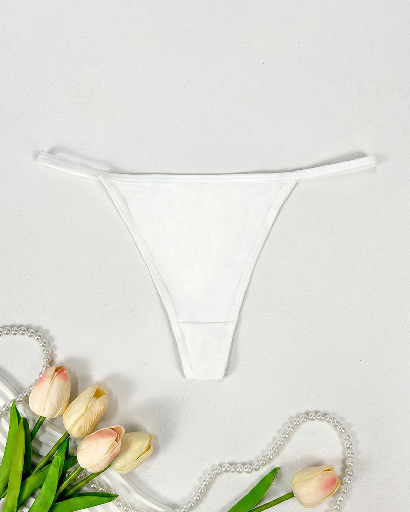 Seamless low-rise thong panties in white, smooth minimal-coverage design.
