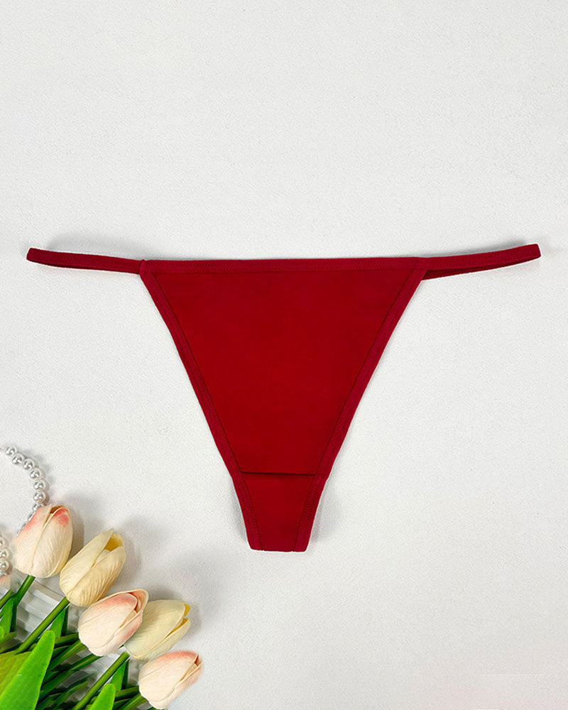 Seamless low-rise thong panties in wine red, smooth minimal-coverage design.