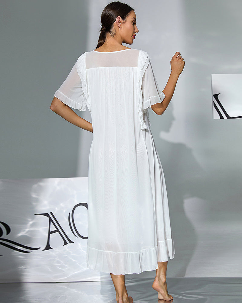 White nightgown with flowing ruffle sleeves and tiered hem, shown from back