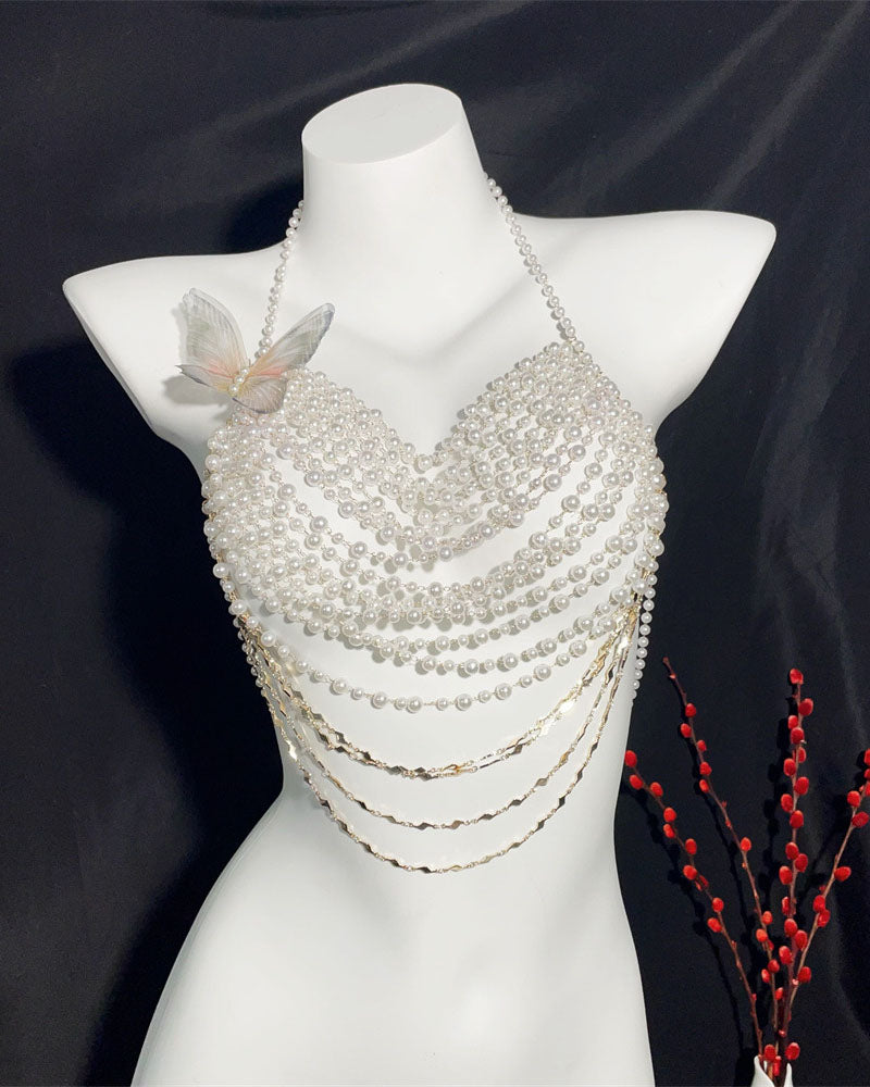 Pearl halter top on mannequin with butterfly ornament, layered beads and dangling chains